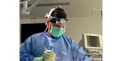 Surgeon performing surgery in an operating room.