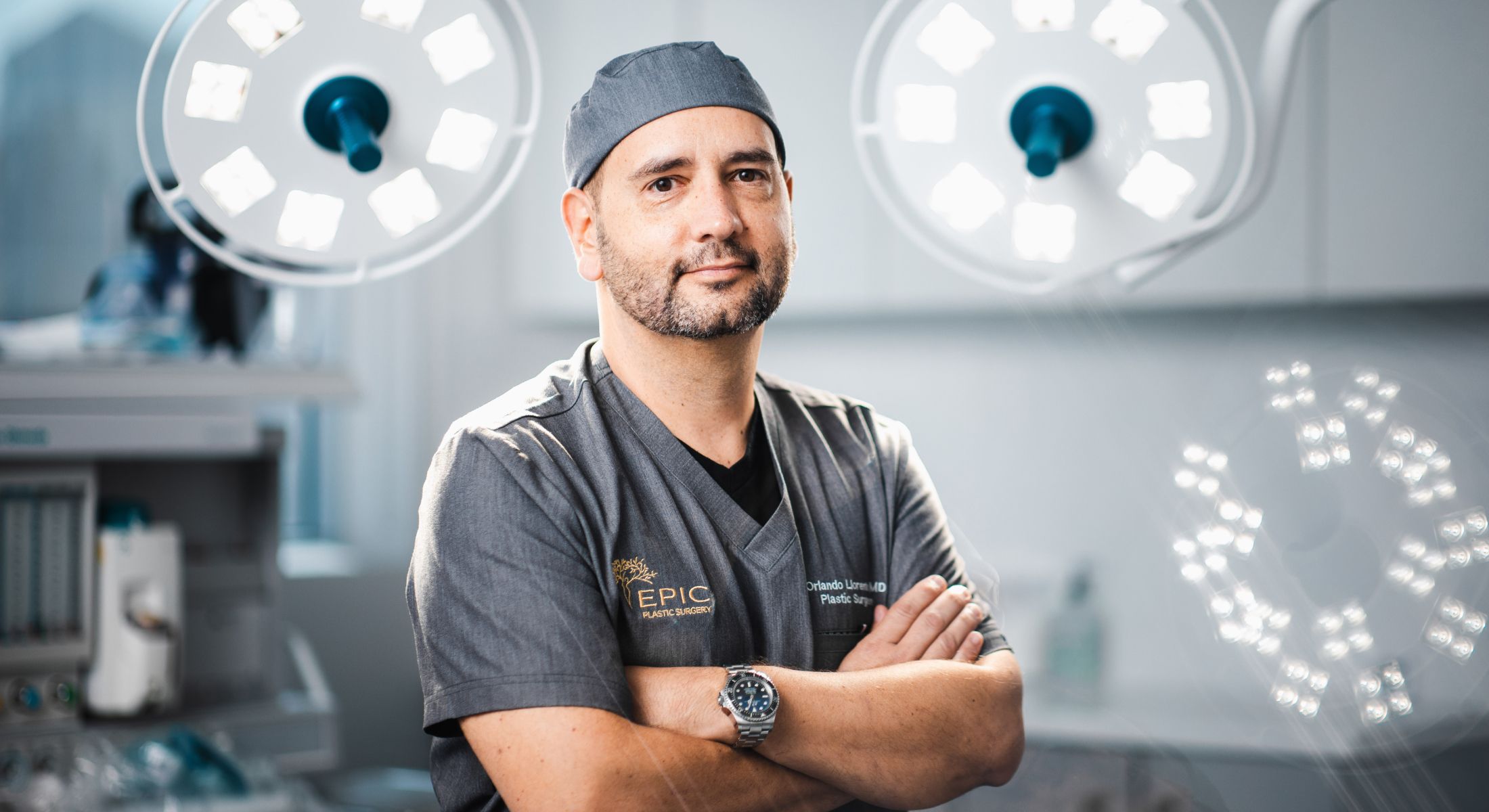 Surgeon posing confidently in operating room.